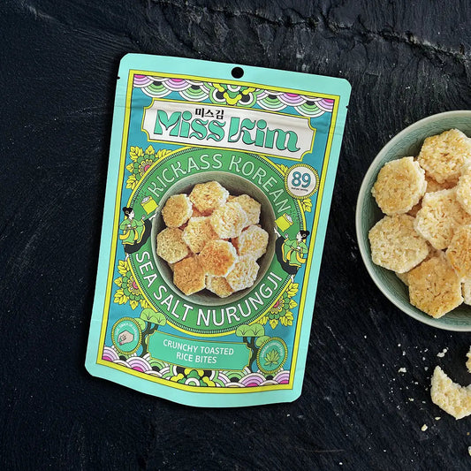 Miss Kim Sea Salt Nurungji with a teacup and tea pot on a dark surface